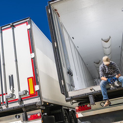 devastated-trucker-sitting-on-semi-truck-trailer-b-2024-05-27-14-05-29-utc
